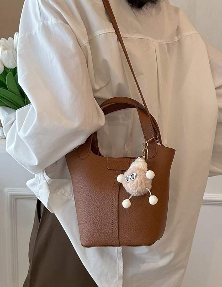 Small Litchi Embossed Bucket Bag With Pom Pom Bag Charm 536700 Small Litchi Embossed Bucket Bag With Pom Pom Bag Charm 536700
